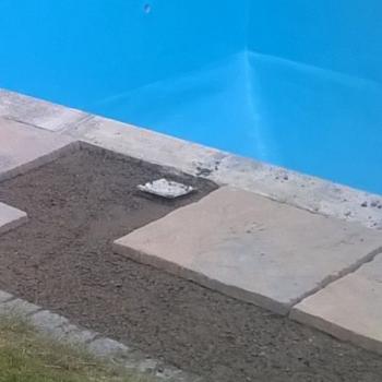 Paving slabs being laid by a pool